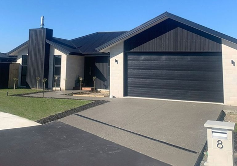 Exposed aggregate driveway and path to front door.
Asphalt vehicle crossing to the road.