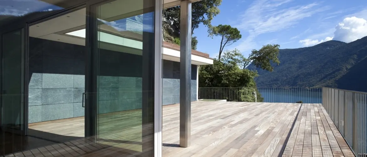 Modern architectural home featuring extensive glazing treated with solar control window film to enhance thermal performance and reduce glare.